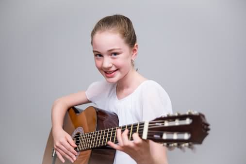 Rogers student with acoustic guitar